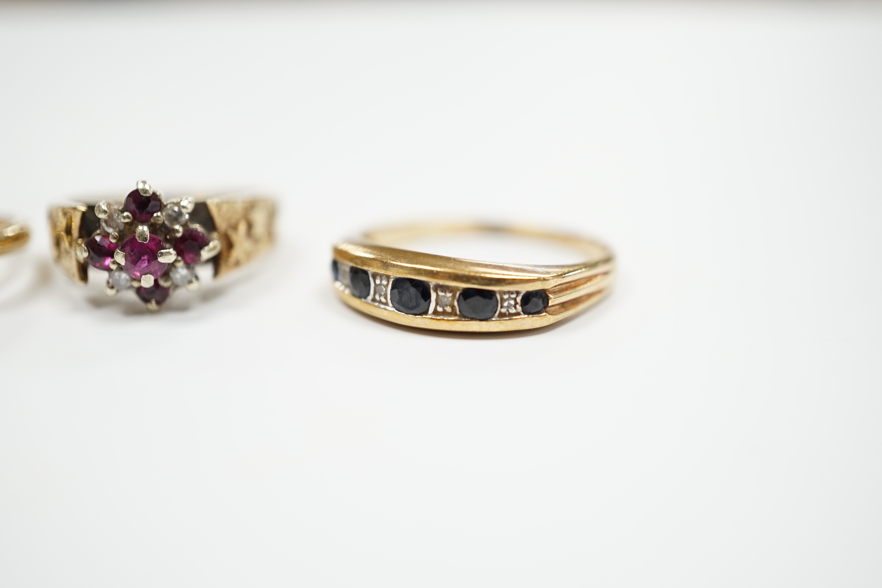Three assorted 9ct gold and gem set rings, including ruby and diamond cluster, gross weight 7.7 grams, a 585 yellow metal and cubic zirconia set cluster ring and a yellow metal, garnet and seed pearl set ring, gross weig